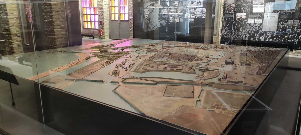 Relief map of Calais in the early 20th century, displayed under glass